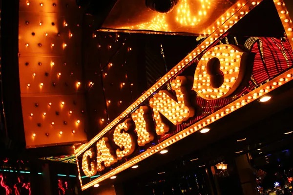 Live casino dealer at blackjack table with multi-camera setup